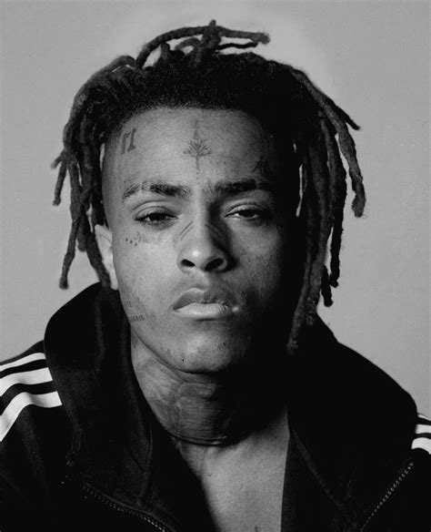 A Black And White Photo Of A Man With Dreadlocks