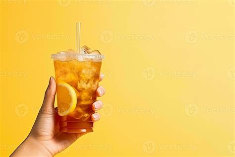 A Hand Holding Takeaway Plastic Cup Of Delicious Iced Lemon Tea