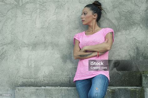 Beautiful Girl Leaning Against Concrete Wall Stock Photo Download