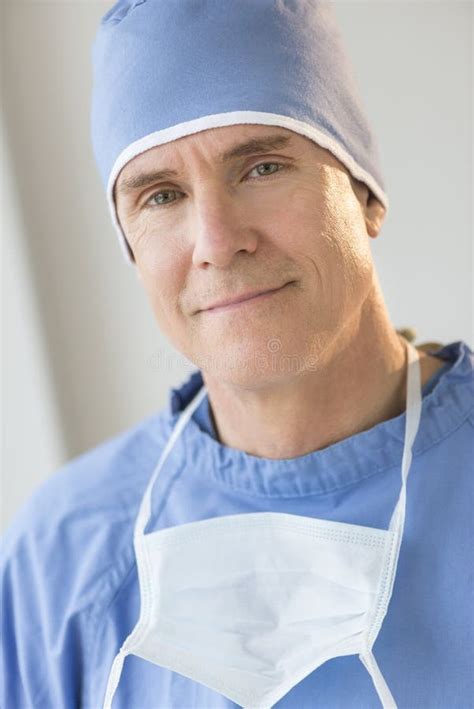 Portrait Of Confident Surgeon With Surgical Mask And Cap Stock Photo