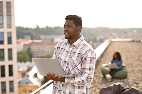 Premium Photo African Male Freelancer Using Portable Computer For