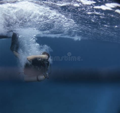 Young Scuba Diver Jumping Into The Water Stock Photo Image Of Reef