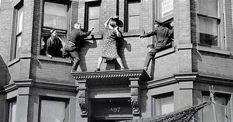 A Woman Fights With The Police As They Try To Prevent Her From Jumping Off The Second Story