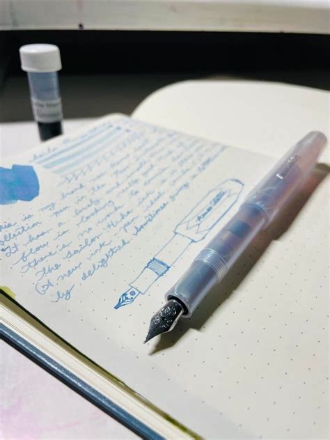 A Pen Sitting On Top Of An Open Notebook