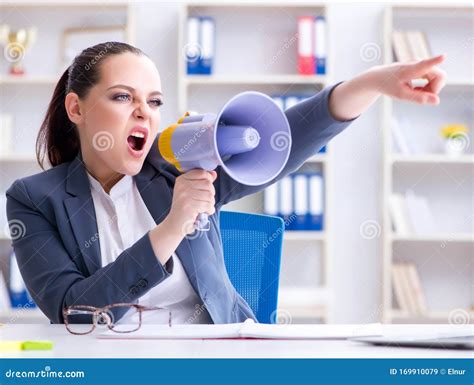 Angry Businesswoman Yelling With Loudspeaker In Office Stock Image