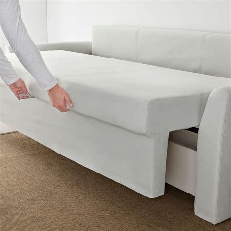 A Person Is Pulling The Mattress Off Of A Couch