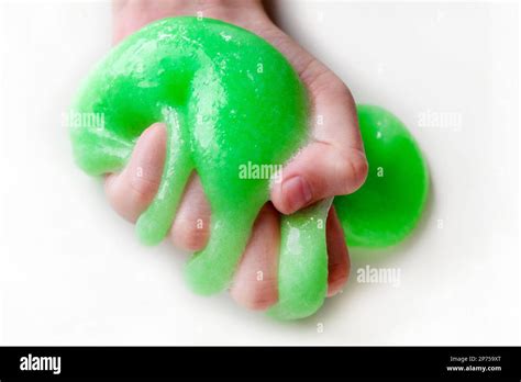 Hand Playing With Textured Slime With Bubbles Stretching The Gooey