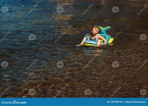 The Boy Floating On An Inflatable Baby Boat Stock Image Image Of