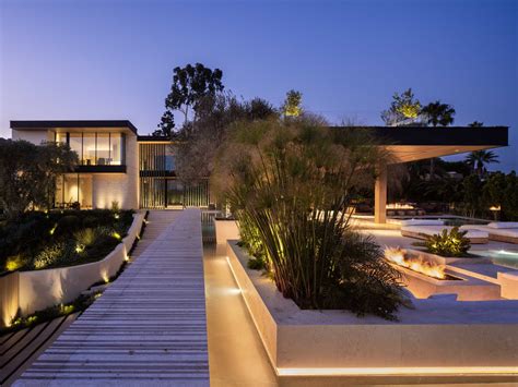 Exterior Lighting Illuminates The Landscaping Around This Modern House ...