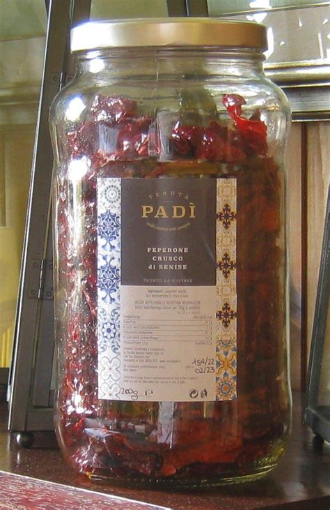 A Jar Filled With Dried Cherries Sitting On Top Of A Counter