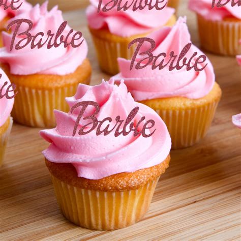 cupcakes with pink frosting and the words barbie above them