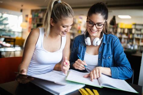 Happy Group Of Friends Studying And Talking Together At University