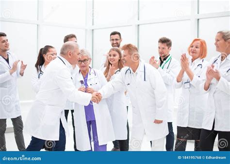 Happy Medical Colleagues Shaking Hands With Each Other Stock Photo