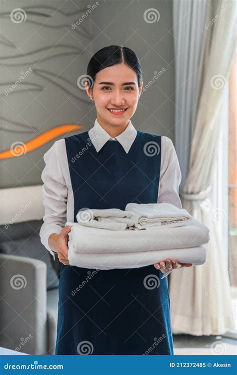 Asian Hotel Maid Holding Fresh Towels Prepare For New Hotel Guest In Bedroom Stock Image Image