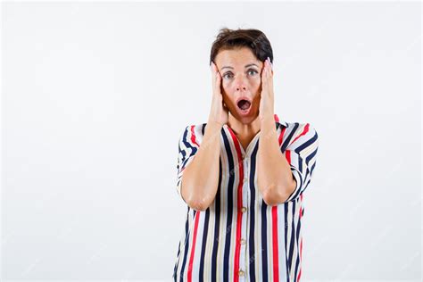 Free Photo Mature Woman In Striped Shirt Holding Hands On Cheeks