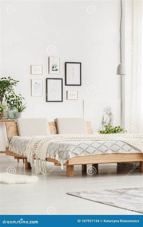 Simple bed and drawings stock photo. Image of apartment - 107957134