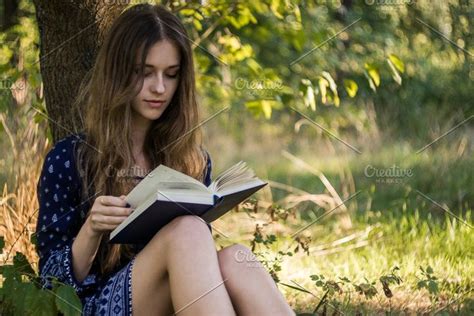 Girl Reading A Book Under A Tree Stock Photo Containing 20 29 And Girl