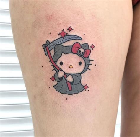 A Womans Thigh With A Hello Kitty Tattoo On Her Left Leg And An Arrow