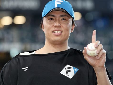 プロ初勝利を挙げ記念ボールを手に撮影に応じる日本ハム田中正