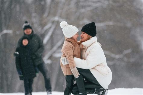 Premium Photo | Happy family is outdoors enjoying snow time at winter ...