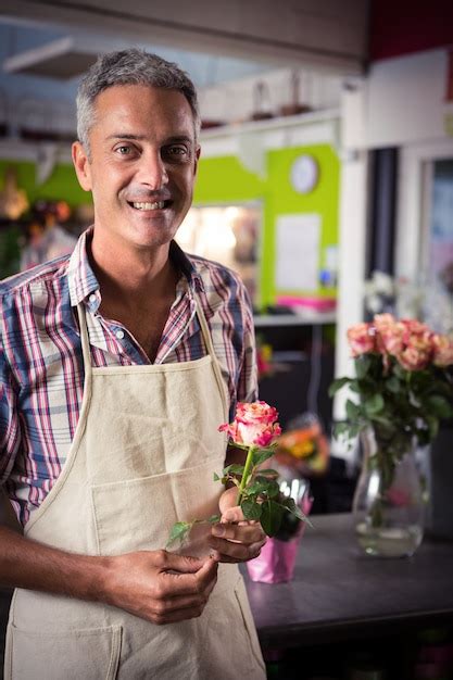 Premium Photo Male Florist Holding Rose At Flower Shop