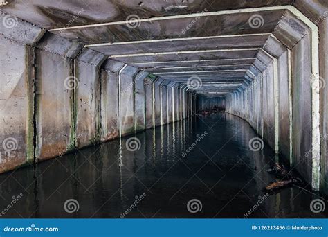 Flooded Sewer Tunnel With Dirty Polluted Water Of Underground River