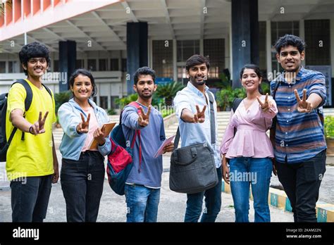 group  college students showing victory sign  gesture