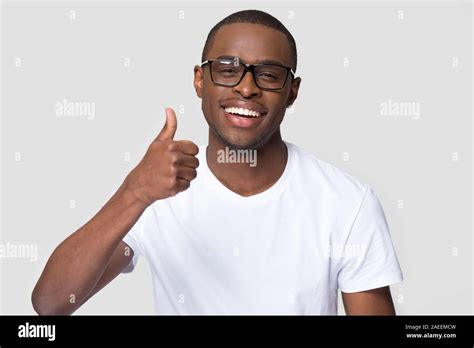 African American Man With Healthy White Smile Showing Thumbs Up Stock