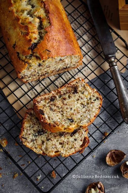 Sliced Loaf Of Banana Bread Sitting On Top Of A Cooling Rack Next To