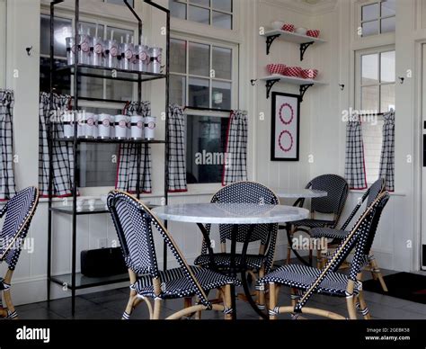 Interior of a restaurant with pattern design of white, black and red colors. Chairs and tables ...