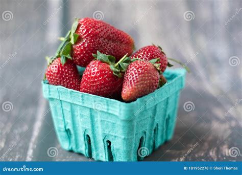 Ripe Strawberries In A Carton And Blurred Background Stock Photo