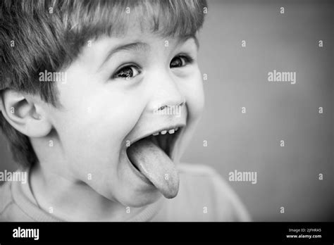 Kids funny face. Close up portrait of a cute little child show tongue. Childhood concept. Tongue ...