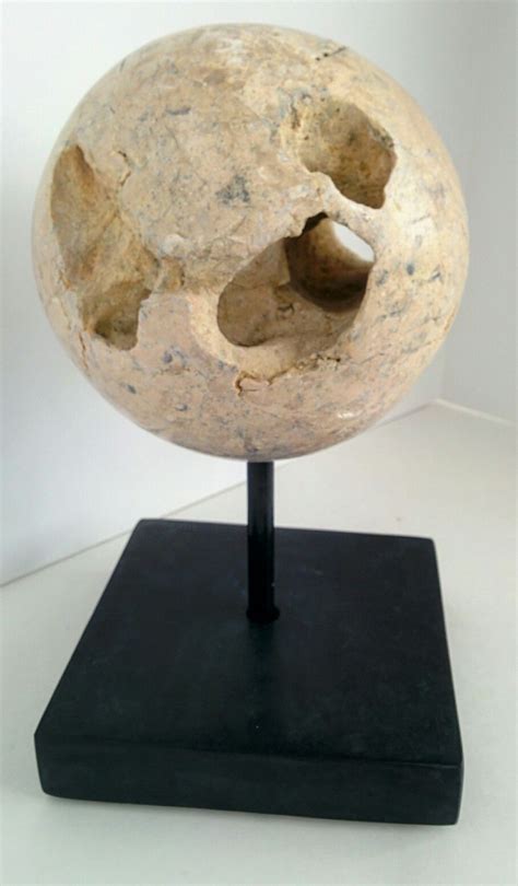 This Volcanic Rock Sphere Sculpture With A Heavy Black Bone Base Is A