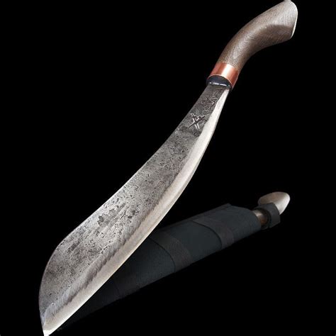 a large knife sitting on top of a black surface