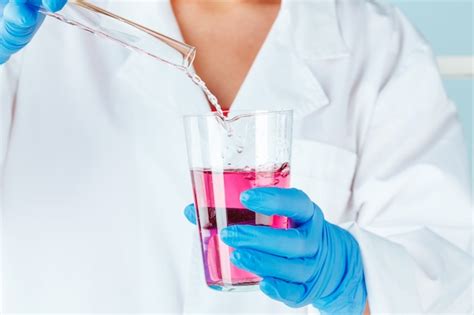 Premium Photo Chemist Hands Holding Test Tubes With Liquids And Doing Experiments