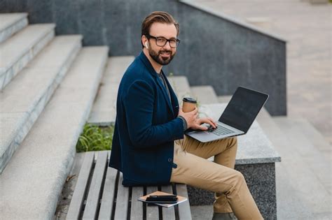 Free Photo Handsome Smiling Bearded Man In Glasses Working On Laptop