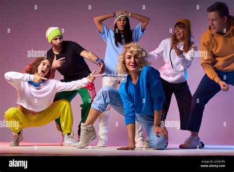 Charming Blonde Woman With Long Curly Hair Dressed In Sportive Brightly Coloured Clothes