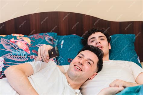 Premium Photo Close Up Of Loving Same Sex Male Couple Lying On Bed At Home Hugging Together