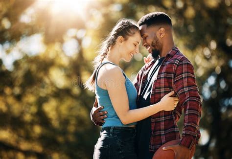 Interracial Couple Outdoor Park And Love With A Hug For Commitment Care And Nature In Summer