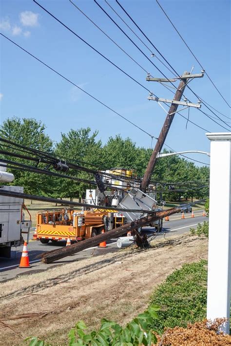 Electric Utility Repair Crew On The Scene Of A Broken Wooden Utility