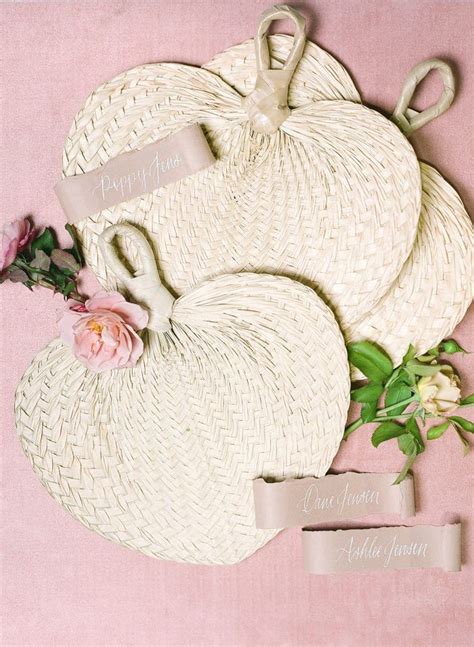 Two White Wicker Pumpkins And Some Flowers On A Pink Background With