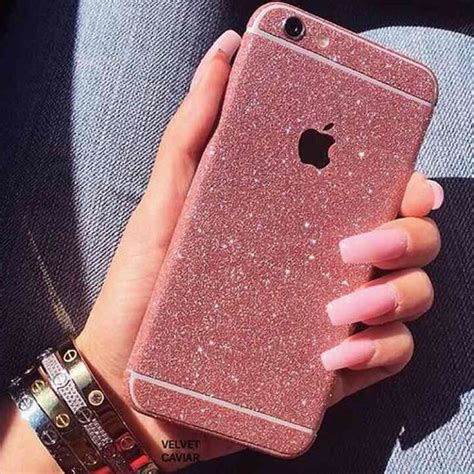 A Womans Hand Holding An Iphone Case With Pink Glitter On The Front