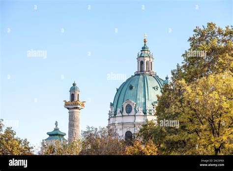 Main dome of Karlskirche on the Karlsplatz square in Vienna, Austria surrounded by autumn trees ...