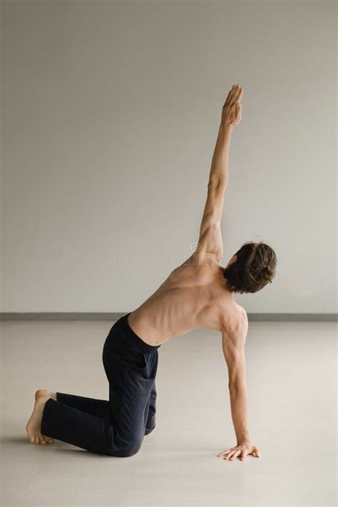 A Man With A Naked Torso Does Yoga In The Gym The Concept Of A Healthy Lifestyle Stock Image
