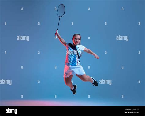 Strong Beautiful Dwarf Woman Practicing In Badminton Isolated On Blue