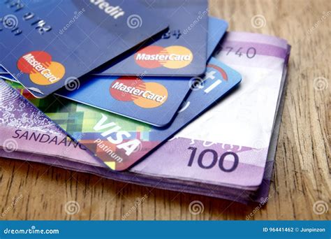 A Bunch Of Mastercard And Visa Credit Cards And One Hundred Philippine