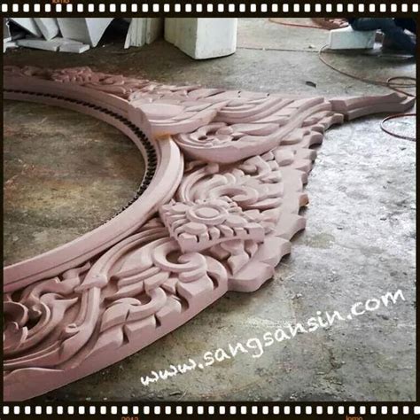 An Intricately Carved Mirror Is Shown On The Ground