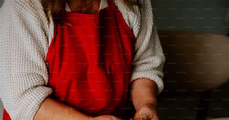 A Woman In A Red Apron Preparing Food On A Table Photo Recipe Image