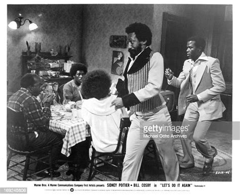 Bill Cosby and Sidney Poitier run past a table in a scene from the ...