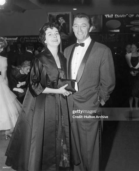 American actor Robert Mitchum and his wife, Dorothy, pose together at ...